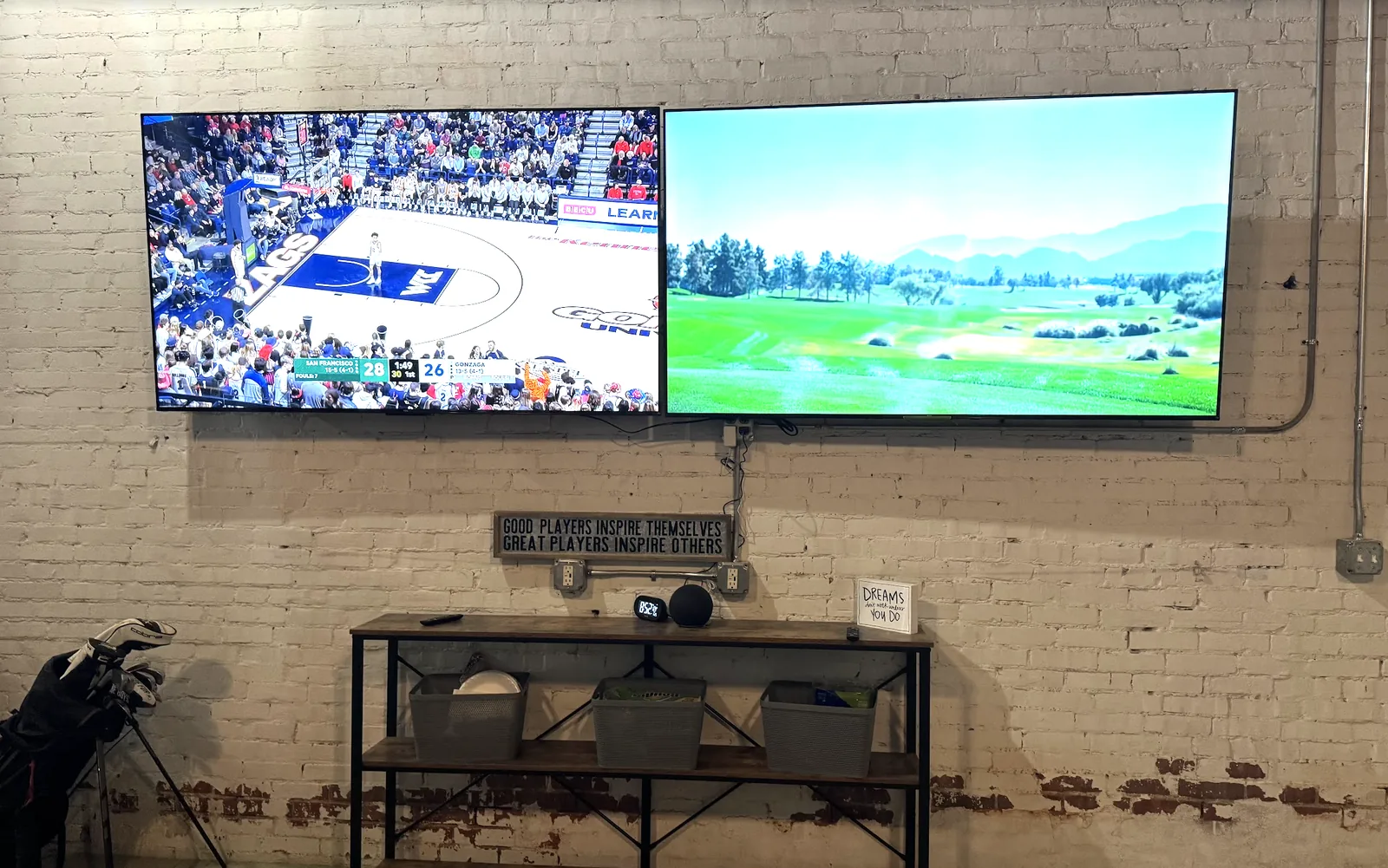 Two 75 inch TVs on the brick wall